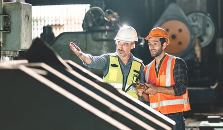 Technicians reviewing manufacturing equipment
